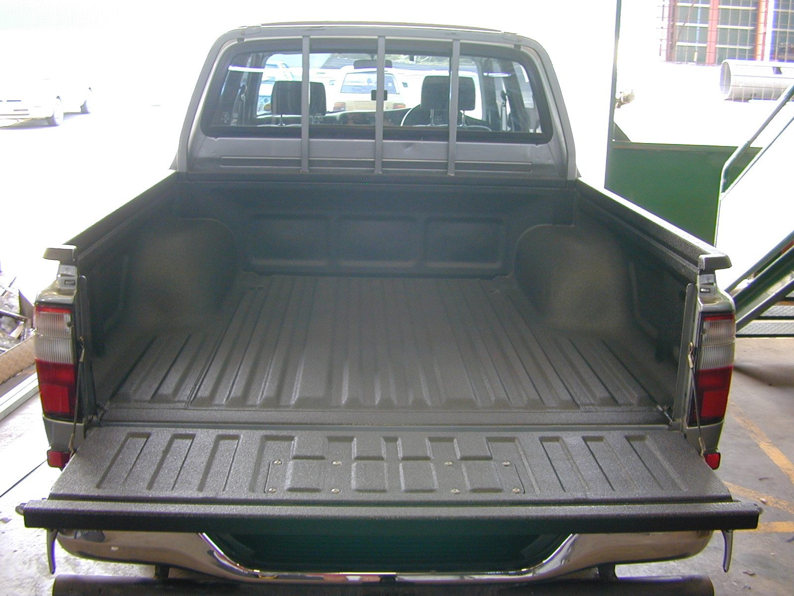 High-build polyurea coating on truck bed and rails